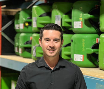 SERVPRO employee standing in front of SERVPRO fans